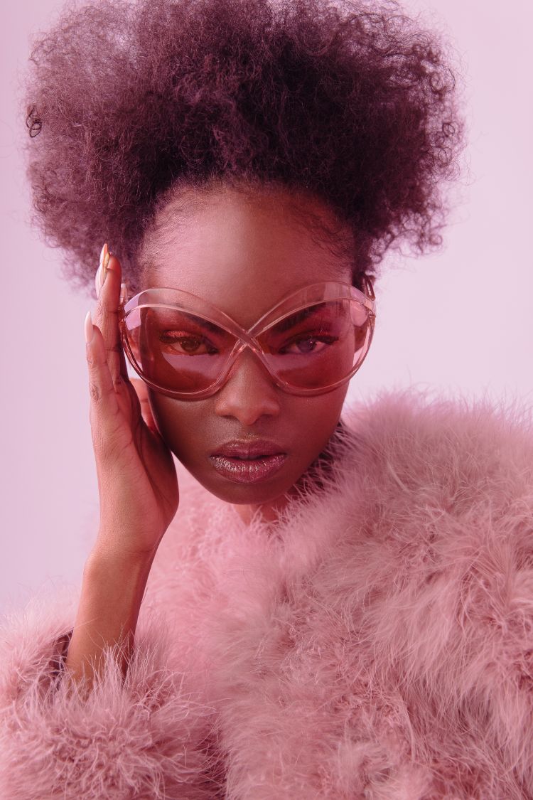 model wearing pink butterfly Tom Ford sunglasses and a feather jacket