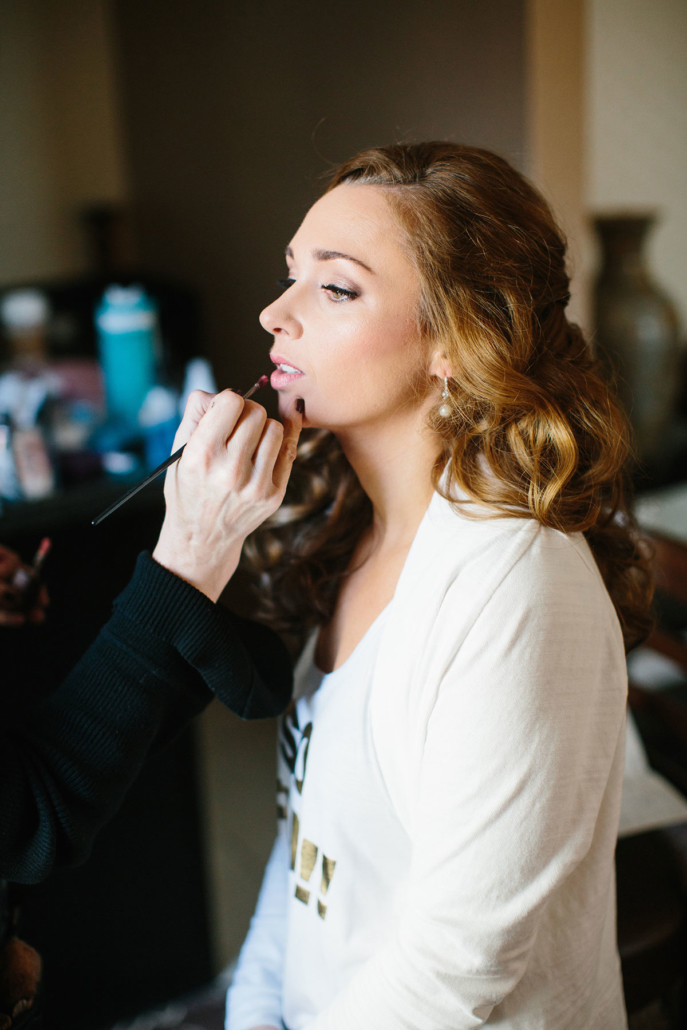 a Bride having her makeup done to preview her makeup look before the wedding day