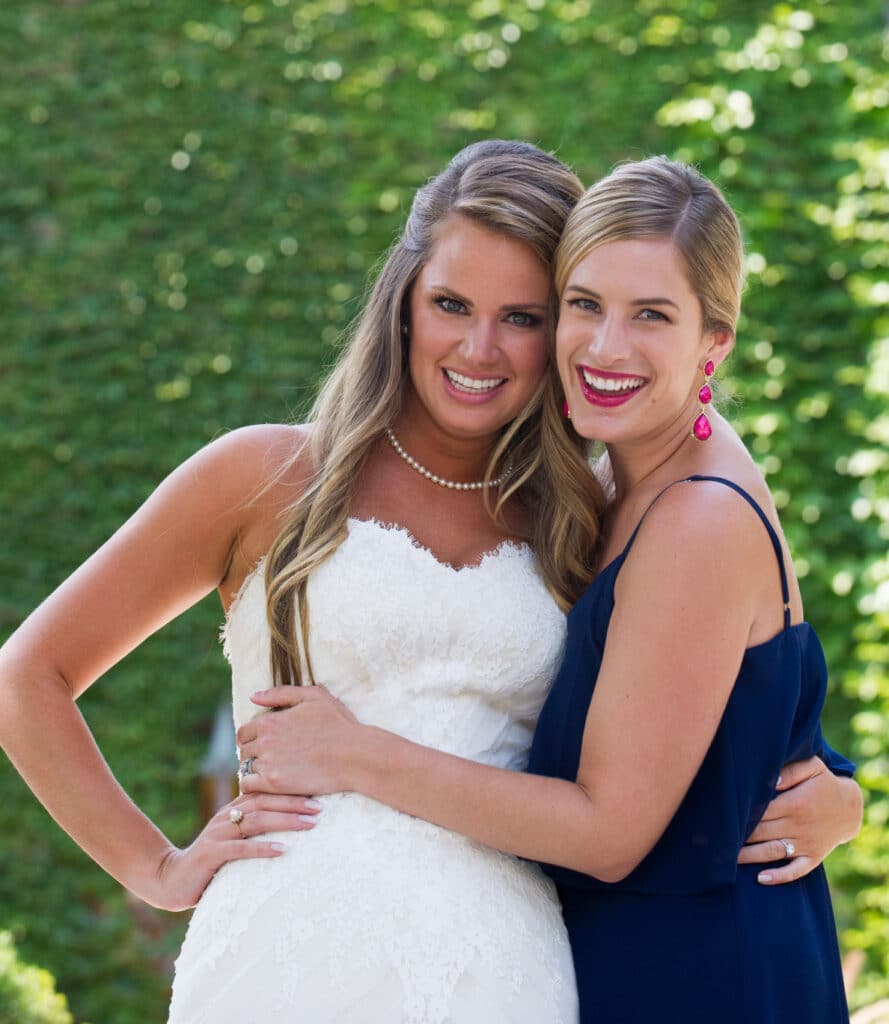 Bride and Maid of Honor hugging in a photo at the Bride's Northfield home on her Wedding day