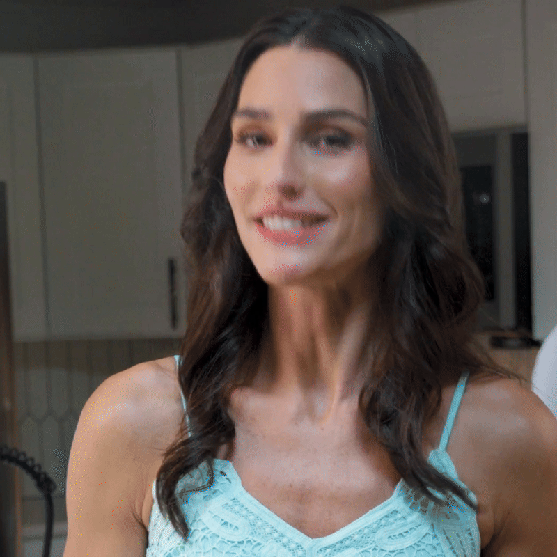 woman standing in her kitchen talking about Microsoft Copilot and Outlook use for help with dinner party organization