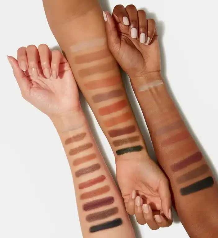 foundation makeup color swatches on the arms of three diverse colored skin tones