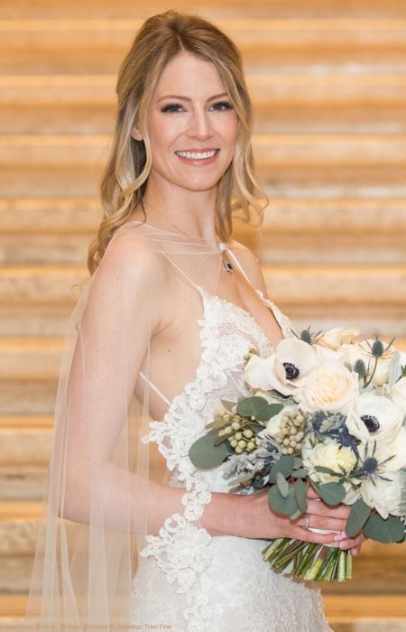 Beautiful blonde Bride holding her wedding bouquet at Chicago's Union Station Great Hall.