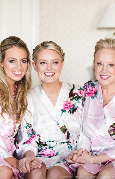 Bride, Mother of the Bride, and Maid of Honor in their wedding day robes wearing a monochromatic bridal look.