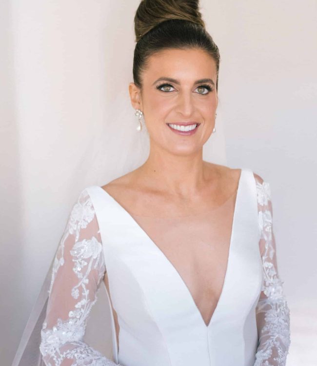 Greek American Bride in her wedding dress, up-do hairstyle and bridal makeup